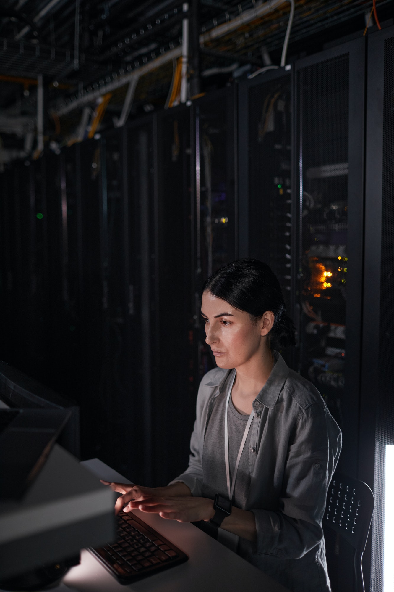 Young Woman Using Computer in Server Room